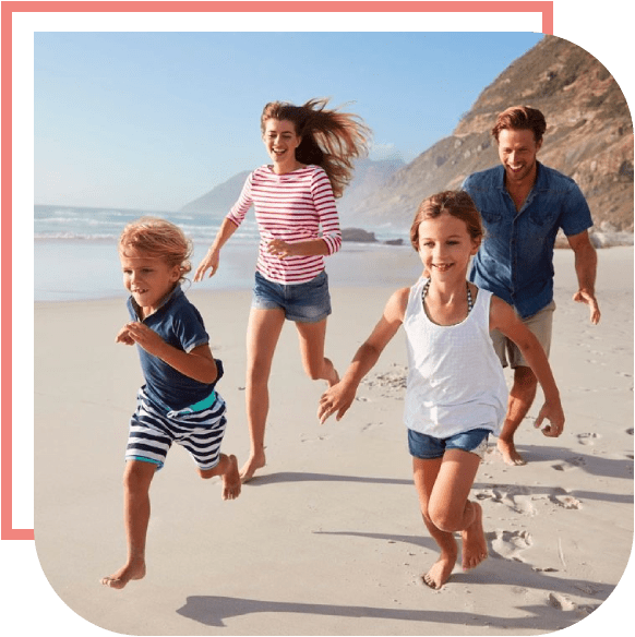 A family running on the beach with one child